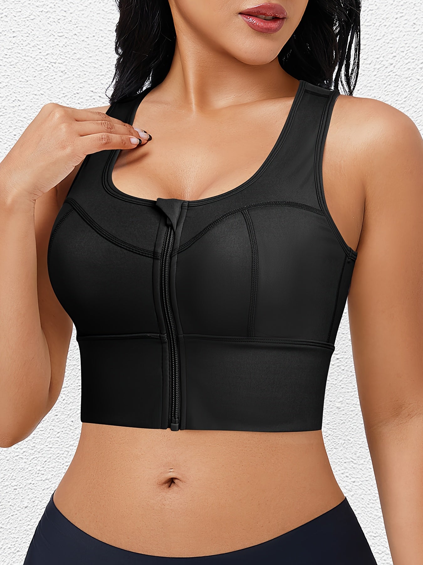 Sports bra with full coverage and zip closure designed to support curvy bodies.