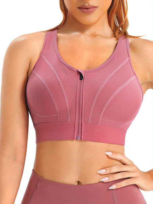 Zip front wireless sports bra in soft pink with secure support and breathable fabric.

